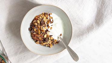 Recette de granola au chocolat dans un bol avec du lait sur une serviette blanche